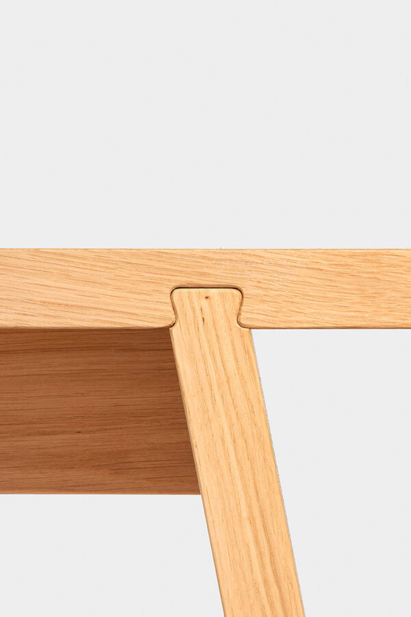 Dovetail Bench – Bank – Detailansicht eines hellen Holztisches mit stabilen, schrägen Beinen und präziser, sichtbarer Verbindungstechnik.