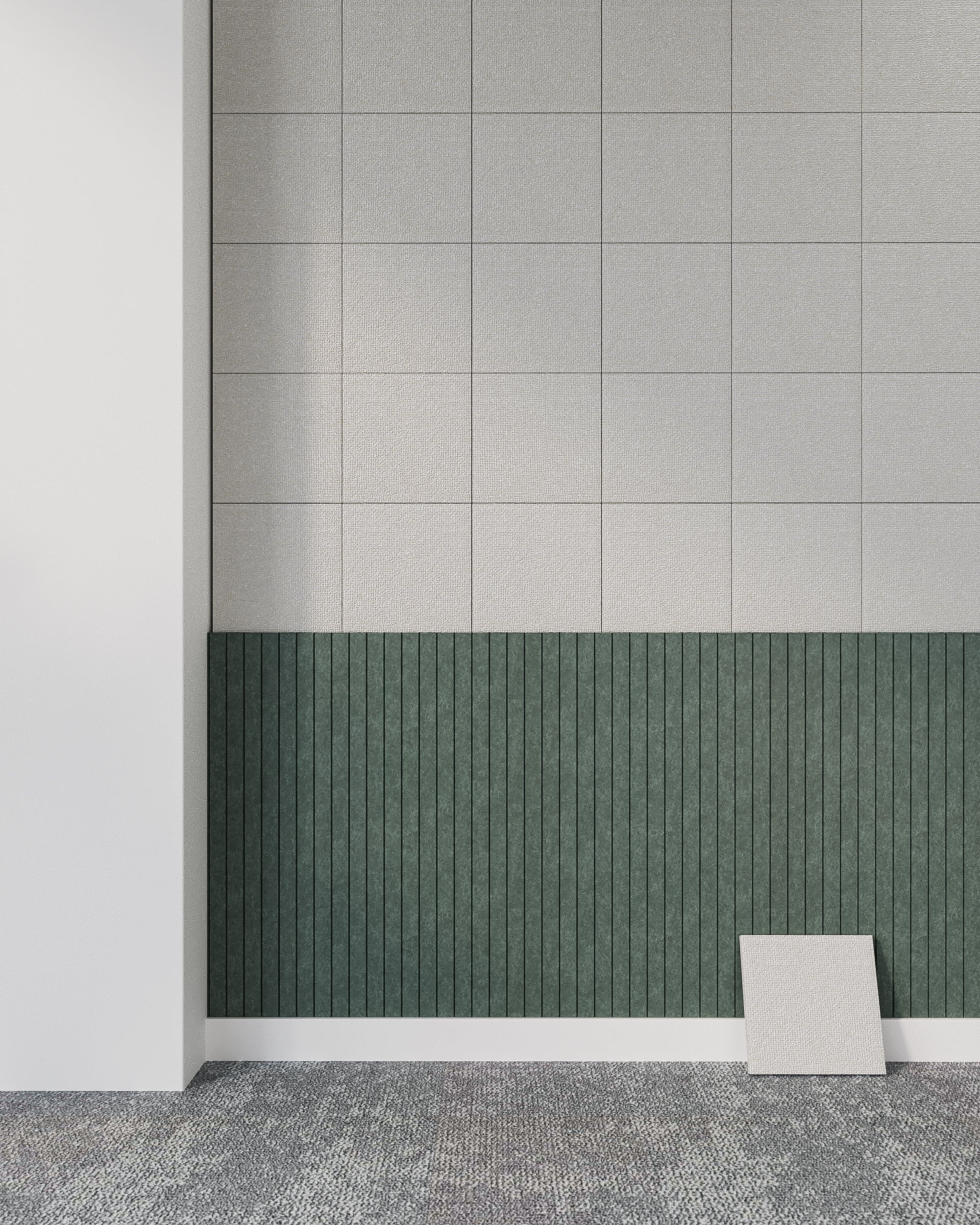 Archisonic Cotton Tofu – Akustische Wandverkleidung – Wand mit grauen Fliesen oben und grüner Paneelverkleidung unten, daneben liegen zwei lose Fliesen auf einem geometrischen Teppich.