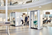 se:cube S – Telefonbox – Moderne Bürolandschaft mit zwei schallisolierten Glasbesprechungskabinen und mehreren Arbeitsplätzen im Hintergrund.