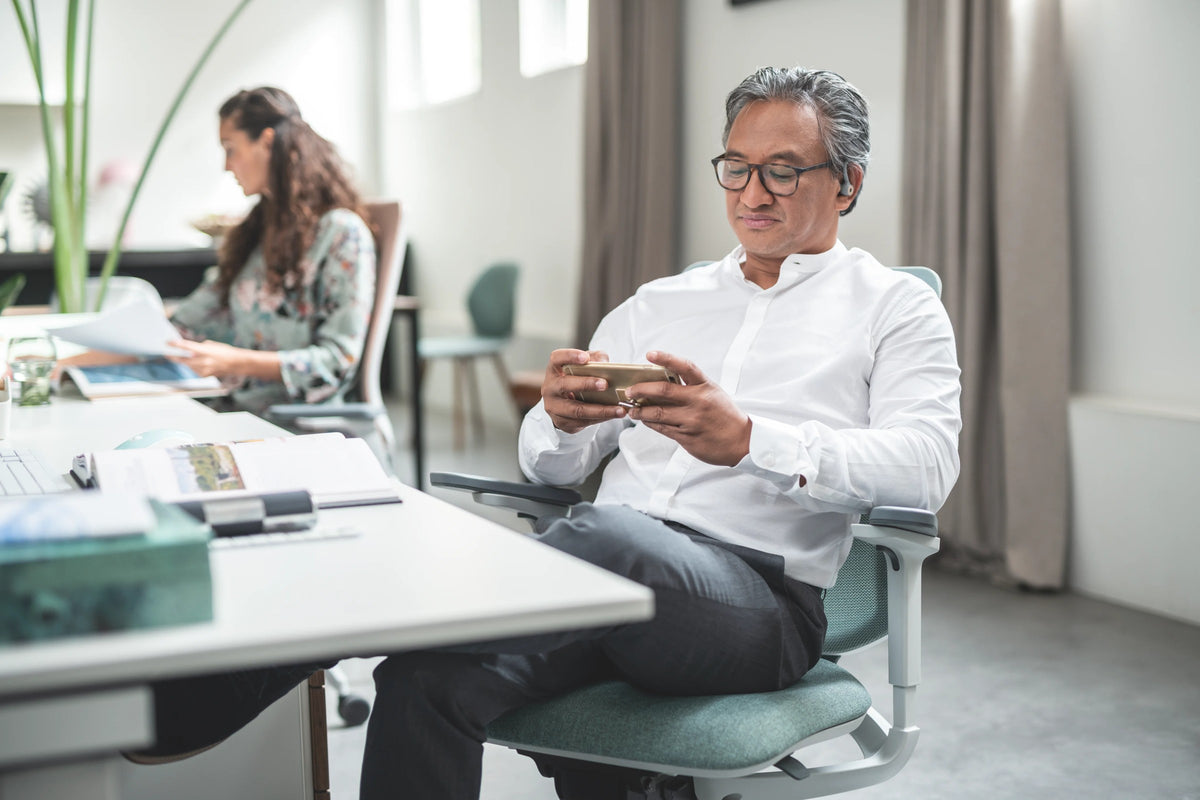 se:flex Bürodrehstuhl von Sedus am Schreibtisch beim Lesen.